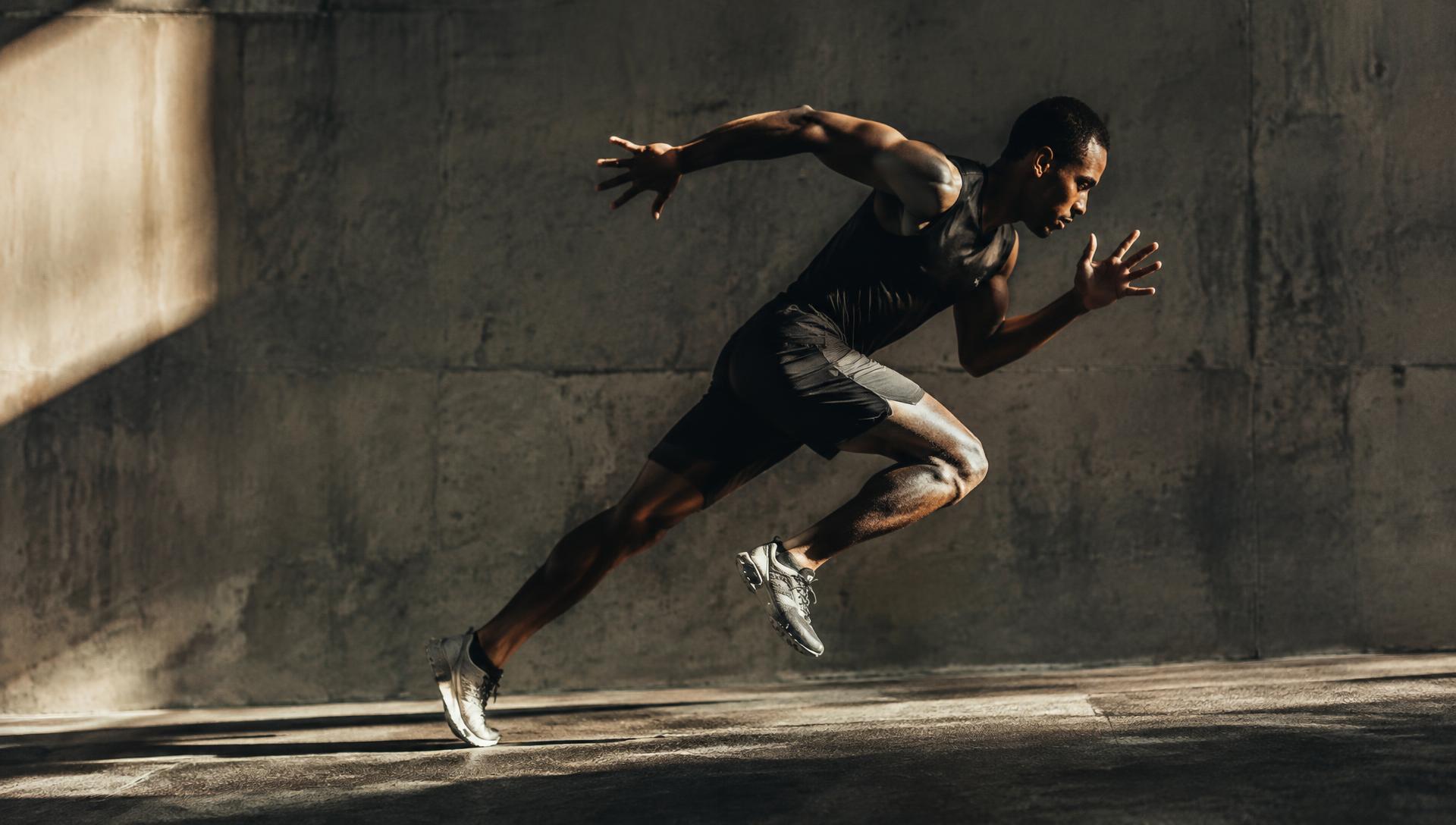 Athlete accelerating in a concrete training space